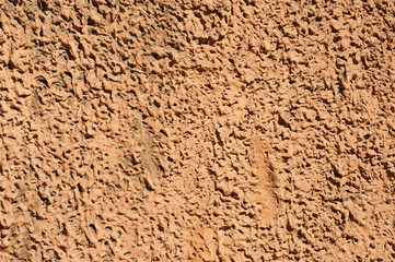 Texture of old wall covered with brown stucco