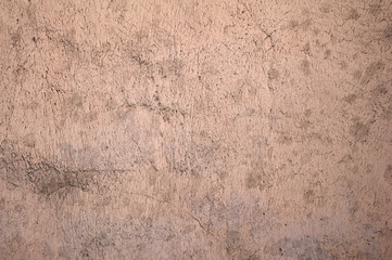 Texture of old wall covered with pink stucco