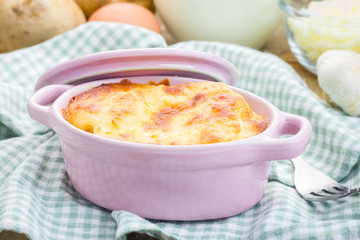 Potato gratin in ceramic mini cocotte