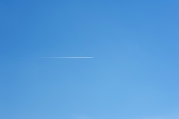 Texture of blue sky withhout  clouds with a trace of jet
