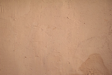 Texture of old wall covered with brown stucco
