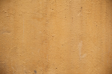 Texture of old wall covered with yellow stucco