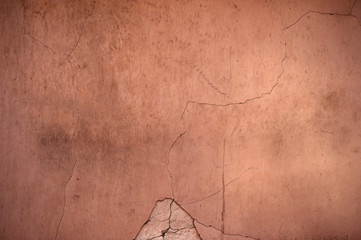 Texture of old wall covered with red stucco