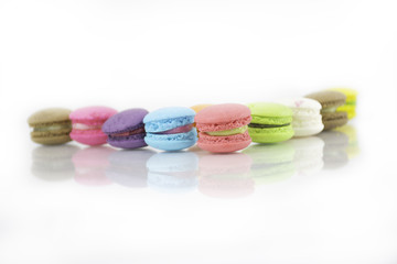 Obraz na płótnie Canvas French colorful macarons isolated on white with path