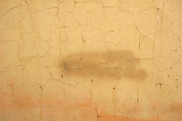 Texture of old wall covered with yellow stucco