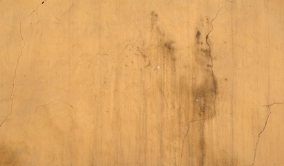 Texture of old wall covered with yellow stucco