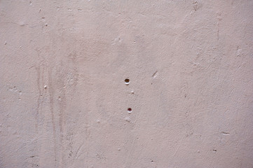 Texture of old wall covered with pink stucco