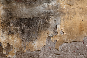 Texture of old wall covered with yellow stucco