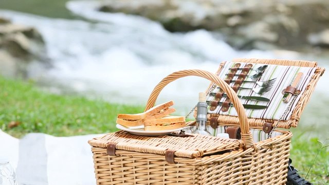 Closeup of picnic basket set by river