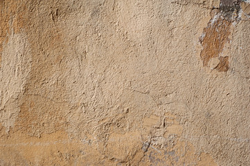 Texture of old wall covered with yellow stucco