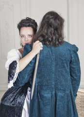 Beautiful woman in medieval dress with dagger hugging man