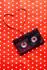 Audio tape cassette on red paper background