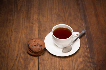 Stilllife with a cup of black tea on the wooden table