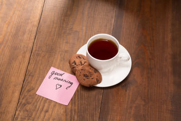 Stilllife with a cup of black tea on the wooden table