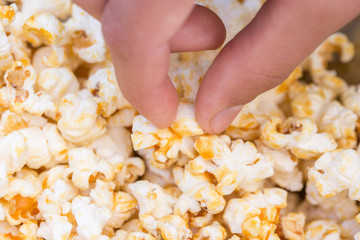 hand taking delicious caramel popcorn