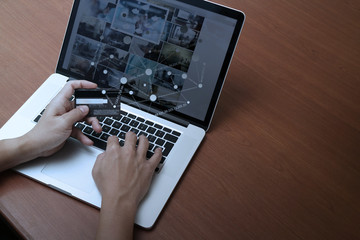 top view of hands using laptop and holding credit card with soci