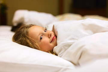 Obraz na płótnie Canvas Little girl in bed