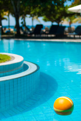 The bright yellow ball in the pool