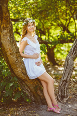 Beautiful pregnant woman feeling lovely. Warm toned image