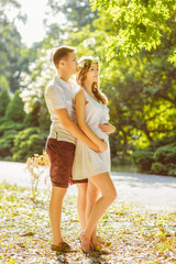 Fototapeta premium Portrait of beautiful loving couple awaiting baby. Husband and