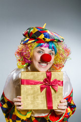 Clown with giftbox in funny concept