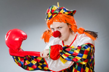 Clown with boxing gloves isolated on white