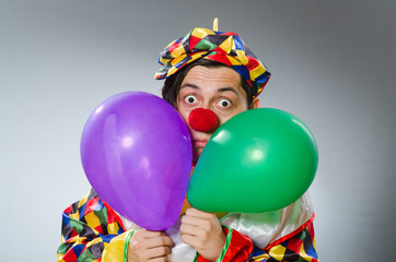 Fototapeta na wymiar Clown with balloons in funny concept