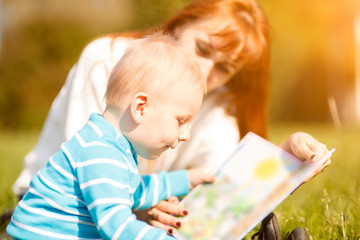 woman with son sitting and read fairytale
