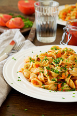 Traditional Italian pasta orecchiette with tomato sauce and vegetables 