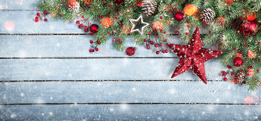 Fir Tree and star On Wooden Background With Snowflakes And Lights
