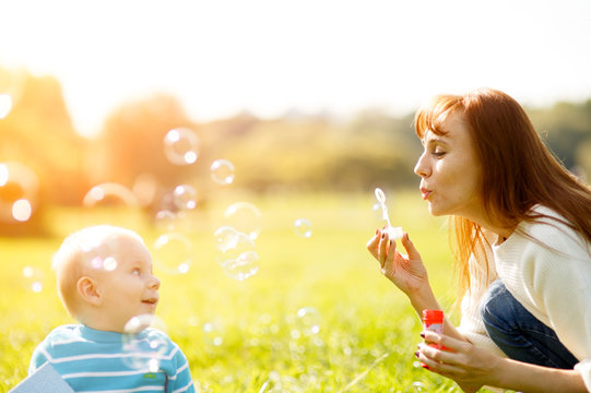 Mother and son making soap bubbles 