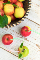 Organic apples in basket, on white vintage wooden background, healthy lifestyle concept