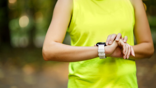 Close up image of woman checking time - Powered by Adobe