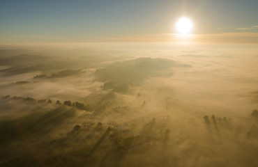 Fototapeta na wymiar Sunrise over the misty fall landscape from the air