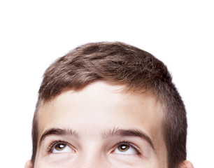 Teen boy looking up, isolated on white background