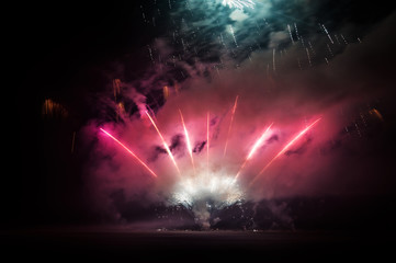 Fototapeta na wymiar Red fireworks on the night sky