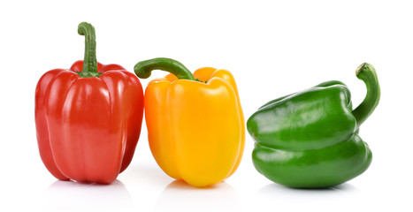 colored peppers over white background