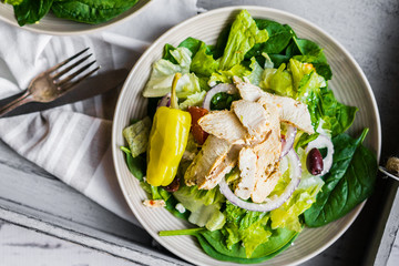 Green chicken salad on wooden background