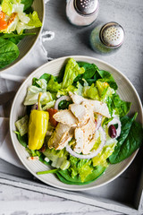 Green chicken salad on wooden background