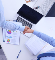 Business people shaking hands, finishing up a meeting, in office
