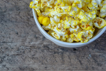Close up Popcorn in glass bowl on old wood background