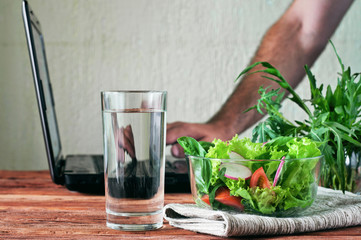 Vegetable salad with a glass of pure water