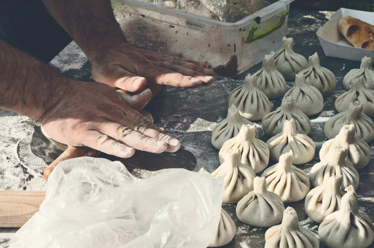 cook prepares khinkali
