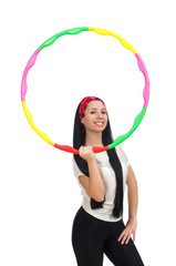 A girl in sport suit with hula hoop isolated on white