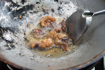 Lean pork fried in a hot pan.
