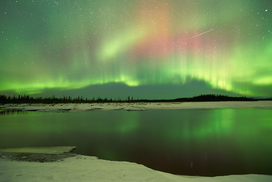 Aurora Borealis Northern Lights over lake in winter at Fairbanks Alaska