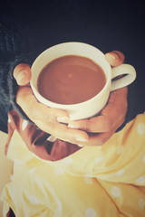 Woman drinking coffee on the bed