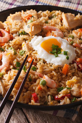 nasi goreng with chicken, shrimp and vegetables close-up Vertical
