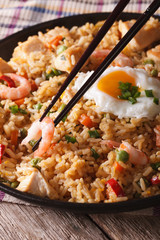 Fried rice nasi goreng with chicken and shrimp close-up vertical
