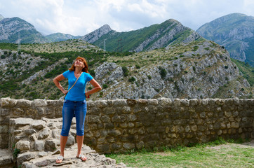 Young woman stands on stone wall of fortress in Old Bar